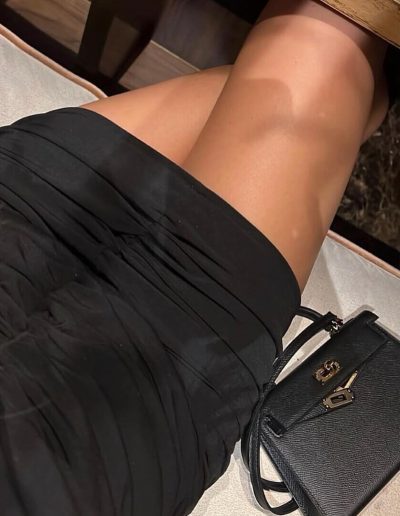 Fernanda Velez posing while wearing Black Draped Dress
